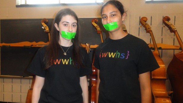 Seniors Emily Aronson, left, and Gouri Mahadwar participate in the Day of Silence.  They taped their mouths shut to represent the members of the LGBT community who feel they are unable to express their sexual orientation. Photo by Lucy Chen.