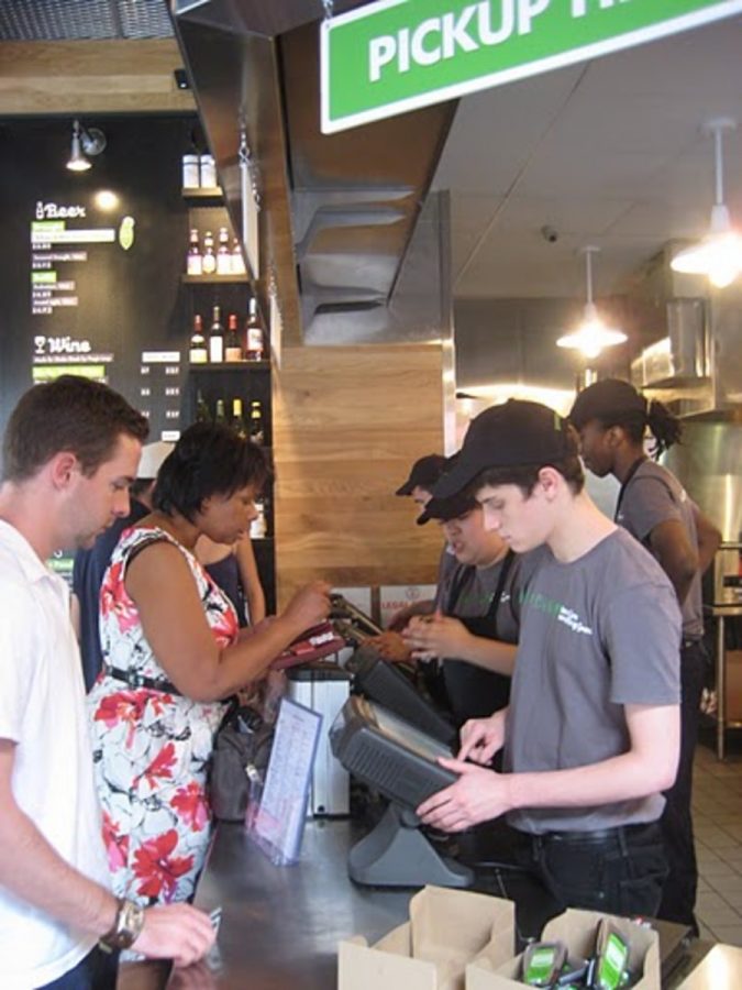 A cashier works the line at the new Shake Shack in D.C. Photo by Eyal Hanfling.