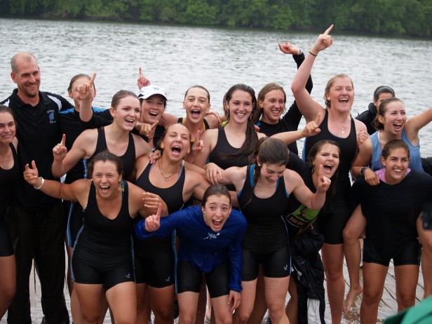 Head coach Kirk Shipley and members of the girls crew team are all smiles after finishing their races at the Washington Metropolitan Interscholastic Rowing Association championship on May 14. The girls won three events in addition to capturing the points trophy. 