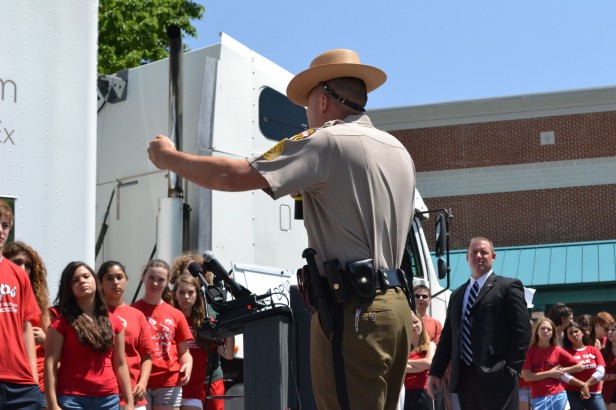 A ranger speaks at the Teens and Trucks news conference outside school today during fifth period. The event highlighted the need for students to avoid a trucks No Zone, and participating students signed a No Texting While Driving pledge. Photo by Abby Cutler.