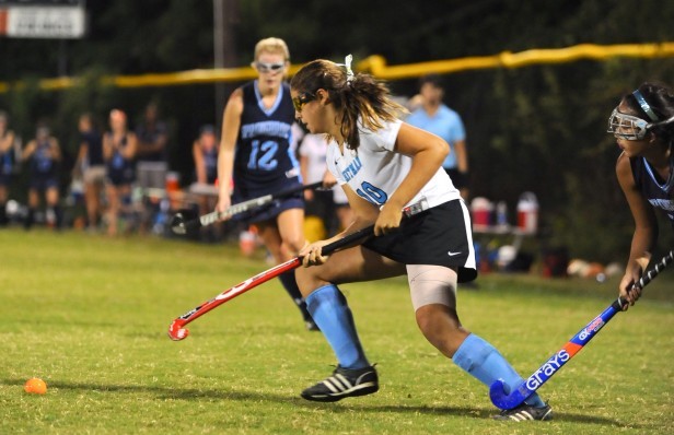 Junior Caroline Seibel pushes the ball past the stick of a Springbrook player. The Vikings lost to the Blue Devils, 3-0, dropping their record to 1-1. Photo by Billy Bird.