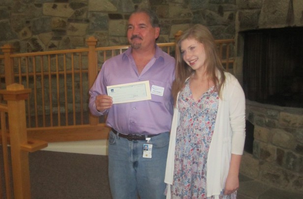 Pyle eighth-grader Hayley Segall presents the NIH Childrens Inn information systems director Rick Saunders with a check for four laptops Sept. 8. Segall hopes to raise enough money to donate more laptops to give sick children more opportunities to communicate with their families. Photo courtesy Hayley Segall. 