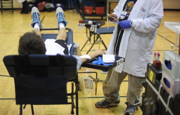 Students give blood for the Fall Blood Drive in the small gym today. Anyone 16-year-old or older, weighing over 110 pounds and meeting other regulations can donate. Photo by Billy Bird.