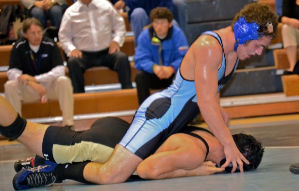 180 lb. wrestler Brad Taylor dominates his opponent during the wrestling teams 52-21 win over the Poolesville Falcons. Photo by Abby Cutler.