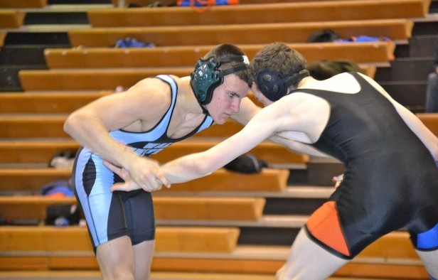 145 lb. Kevin Whitmeyer faces off against his opponent in the first match of the meet. Photo by Abigail Cutler.