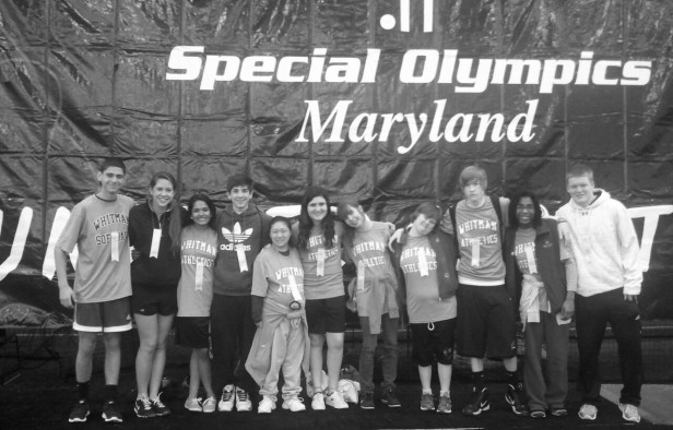 Members of the bocce team pose together in front of a sign advertising the Special Olympics. Photo courtesy Leslie Gillman.
