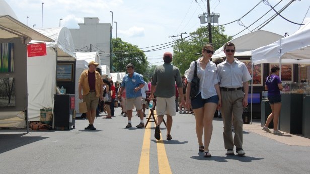 Pedestrians enjoying the arts festival walk in downtown Bethesda. The annual Bethesda Fine Arts Festival took place May 12 and 13. Photo by Annie Katz.