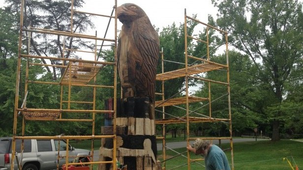 Artist Jim Calder, Jr. works on his carving of a hawk. The school hired Calder to carve the lightning-struck tree. Photo by James Ireland.