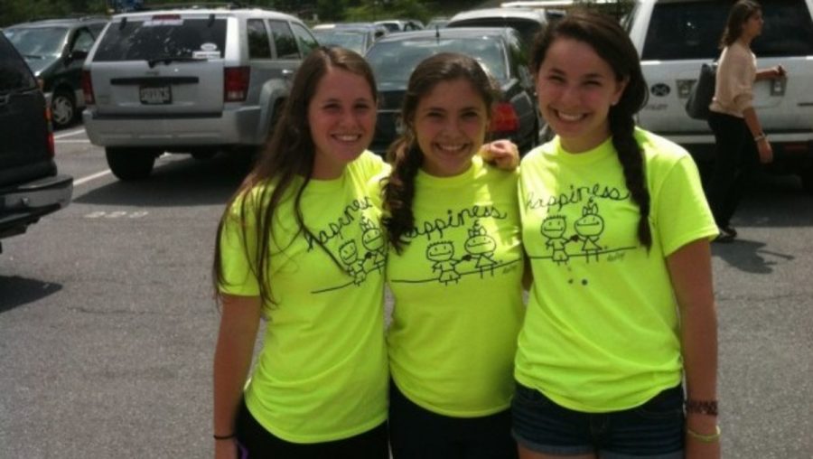 Seniors wore Project Happiness shirts for Seniors Against Drunk Driving Day May 15 to remind people to neither drink and drive nor get in a car with someone who has been drinking.  From left to right: seniors Clara Schneider, Cassandra McAlister, Alana Carmel. Photo by Laura Rostad.