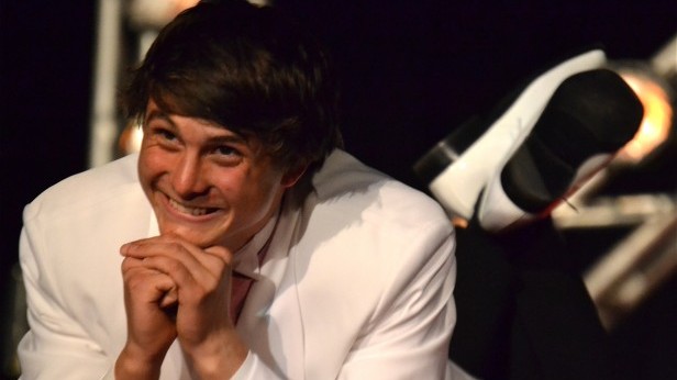 Senior Ryan Davison flashes a heart-stopping grin during Mr. Whitman. Fourteen seniors boys competed for the title of Mr. Whitman May 18. Photo by Abigail Cutler.