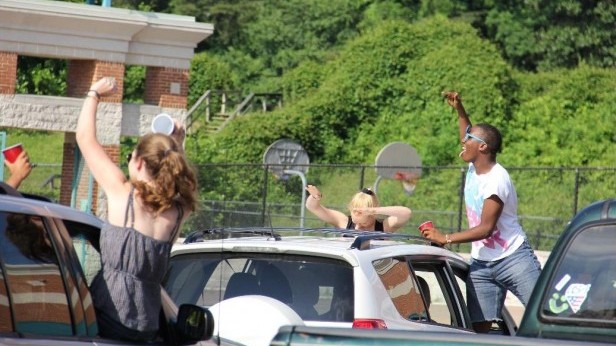 Seniors dance outside during the senior prank. The senior class staged a dance in the bus lane at the beginning of third period today. From left to right: Katie Hunter, Lara White, Soloman Parker. Photo by Paula Ospina.