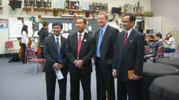 Indonesian senior officials, including Vice Minister of Education Musliar Kasim, pose for a photo in the band room. The group toured Whitman Sept. 20. Photo by Eyal Hanfling.
