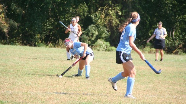 Defender Valerie Acker sinks low and pushes the ball to waiting forward Allie Boyan. The field hockey team beat the Paint Branch Panthers 5-2 Sept. 22. Photo courtesy Deb Lang.