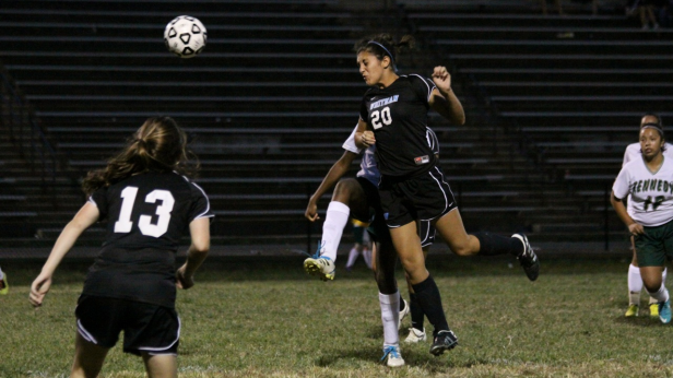 Midfielder Dani Okon heads the ball upfield, as defender Lottie Nalls looks on for the open pass. The Vikes defeated the Kennedy Cavaliers 2-0. Photo by Tom Nalls.
