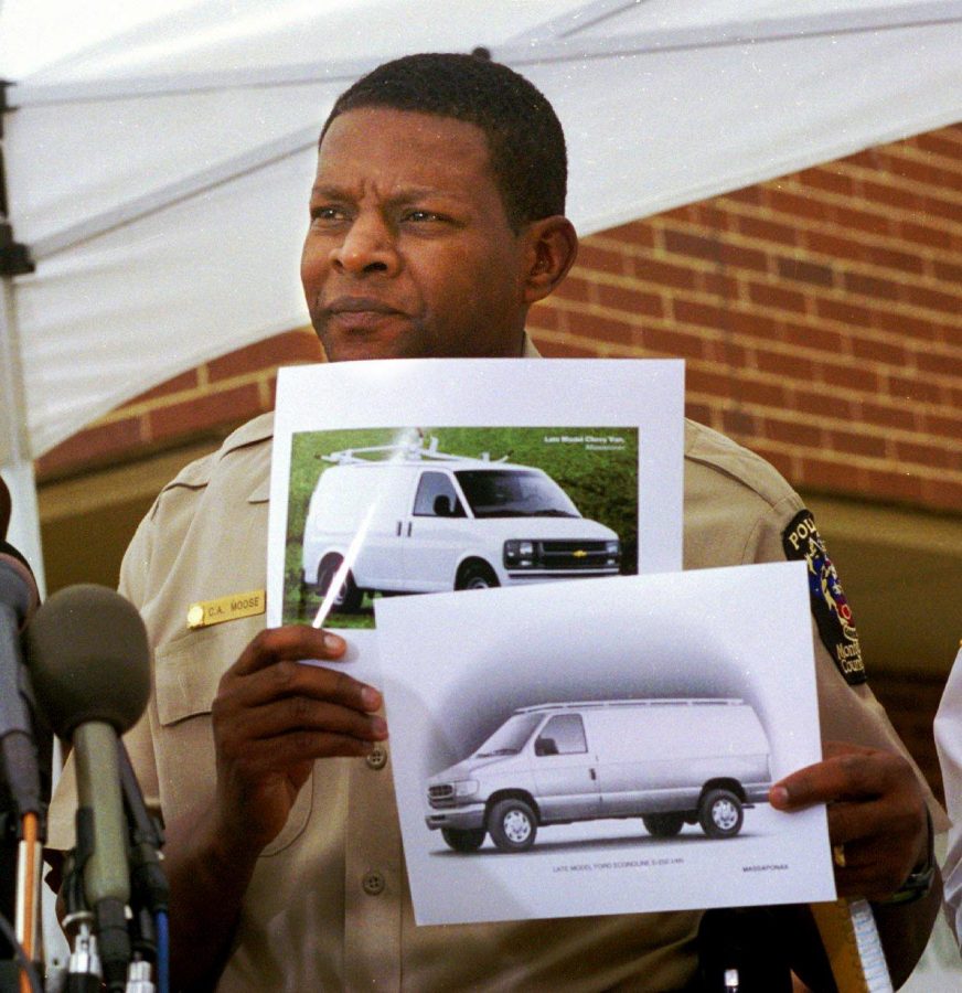 Montgomery County Police Chief Charles Moose holds up two composite images of the snipers van. Sniper attacks persisted, interrupting regular routines and sports practices, throughout Oct. 2002. This October marks the ten-year anniversary. AP Photo/Marie P. Marzi.