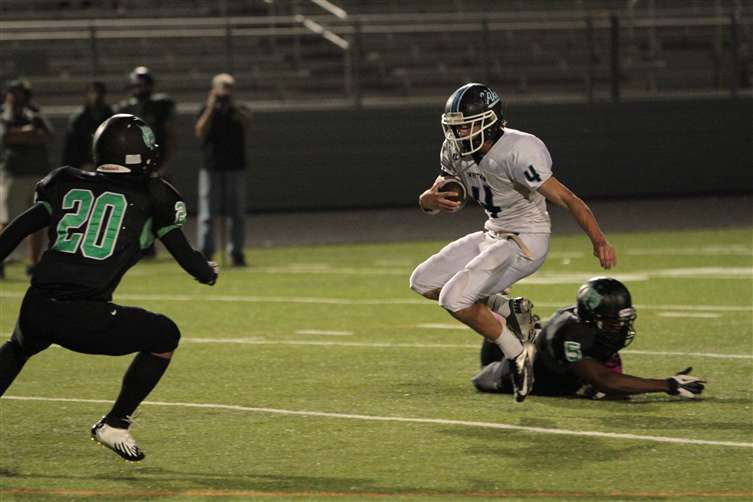 Running back Zac Morton takes on a Wildcat defender. Photo by Chris Hanessian.