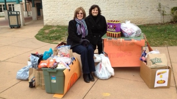 Mover Moms volunteers pose with the collected candy. “No amount is too small,” president Rebecca Kahlenberg said. Photo courtesy Rebecca Kahlenberg.