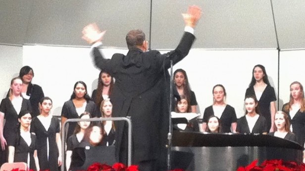 Chorus teacher Jeff Davidson directs a group during the choral concert Dec. 19. Photo by Deanna Segall.