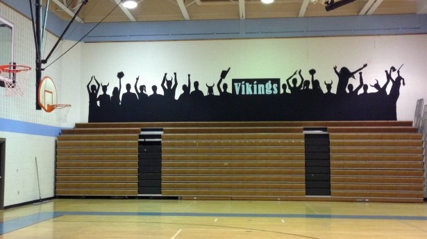 Students painted the silhouette of cheering fans in the gym Sunday. Caroline Crawford organized the event. Photo by Billy Bird.