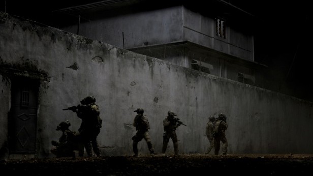 US Navy SEALs storm Osama bin Ladens compound in the detailed and dramatic last scene of Kathryn Bigelows Zero Dark Thirty. Photo Courtesy Sony Pictures.