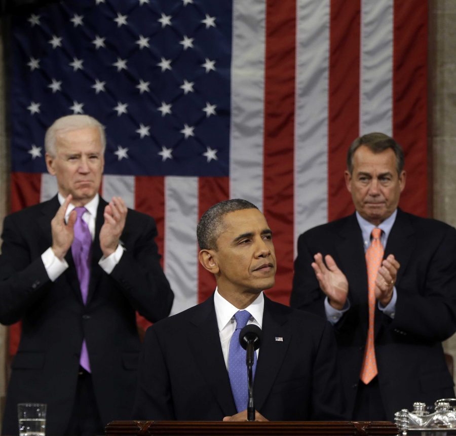President Barack Obama stands between Vice President Joe Biden and House Speaker John Boehner as he gives his State of the Union address. AP Photo/Charles Dharapak, Pool. 