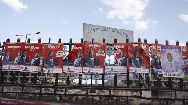 Red signs for a major presidential candidate in Kenya decorate a downtown area. Photo by Marit Bjornlund. 
