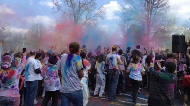 Revelers throw colored powder in the air to celebrate Holi. Photo by Julia Medine.
