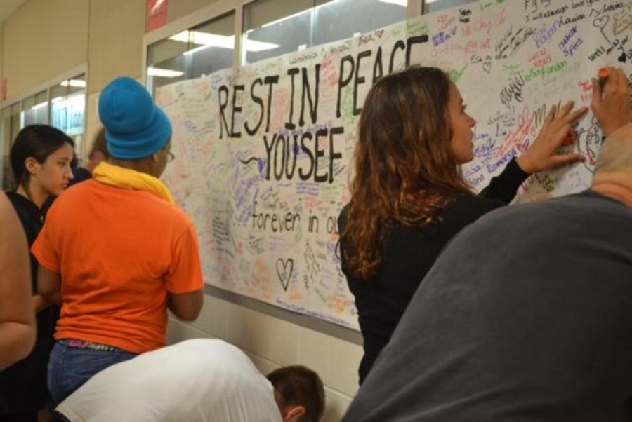 Students record their memories of Yousef. The school also held a candlelight vigil, which 300 students attended.