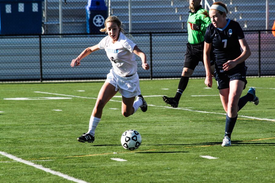 Senior Aliza Wolfe charges towards the ball. Wolfe scored the winning goal against South River today, advancing girls soccer to states. Photo by Tyler Jacobson.