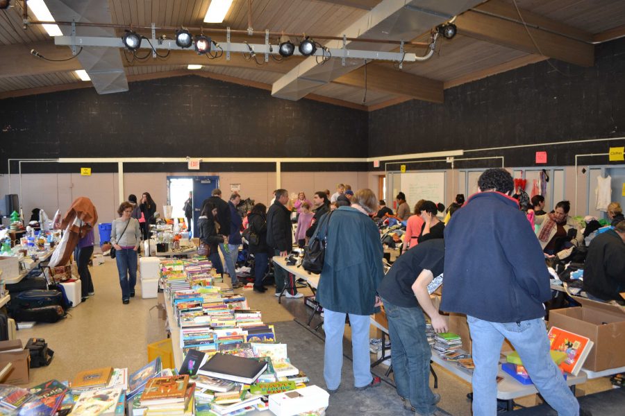 Students, parents and community members rummage through the array of books, clothes and other items at this years second annual yard sale. The Give Us Your Stuff club hosted the sale, which benefitted the Leukemia & Lymphoma Society. Photo by Rebecca Katz.