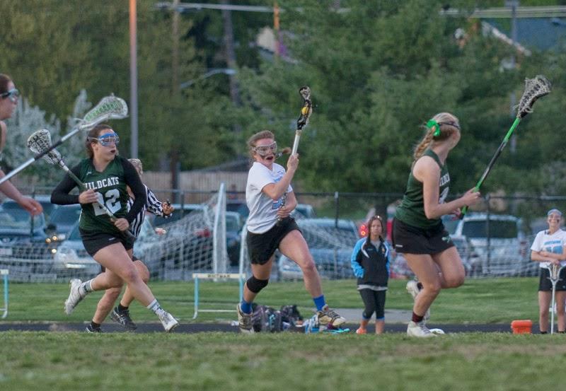 Midfielder Maddie Parker dodges up-field with the ball.  Parker had three goals against the Wildcats.  Photo courtesy Shelly Dane.