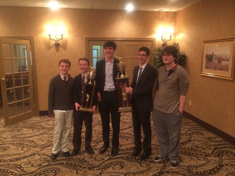 Sam Arnesen, WIll Arnesen, Fionn Adamian, Ben Zimmermann and coach Iaan Reynolds hoist their trophies after winning their semi-final rounds. The teams debated about about prioritizing either the economy or the environment of India. Photo courtesy Daniel Schifrin.