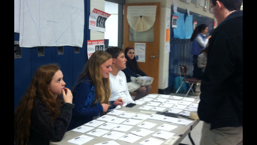 Leadership members help a student through the voting process.  Photo by Sarina Hanfling.