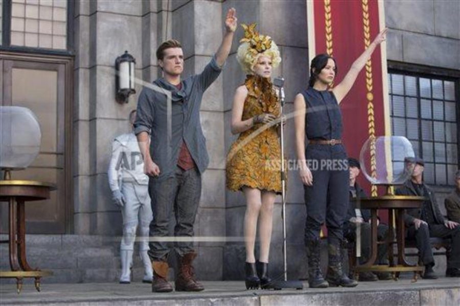 This image released by Lionsgate shows Josh Hutcherson as Peeta Mellark, from left, Elizabeth Banks as Effie Trinket and Jennifer Lawrence as Katniss Everdeen in a scene from The Hunger Games: Catching Fire. The movie opens in theaters Friday, Nov. 22, 2013, in whats expected to be one of the years biggest box-office debuts. (AP Photo/Lionsgate, Murray Close)
