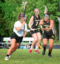 Midfielder Maddie Parker carries the ball down the field in the Vikes 12-11 win over the Richard Montgomery Rockets.  Photo courtesy Shelly Dane.