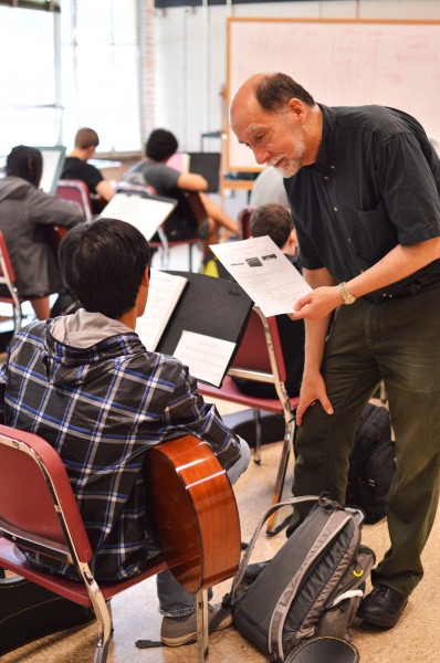 Music teacher Wayne Chadwick helps a student with guitar.  Chadwick also teaches music theory, piano and electronic music at Whitman, and will retire this year.  Photo by Nick Anderson.