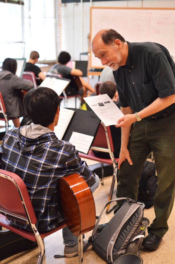 Music teacher Wayne Chadwick helps a student with guitar.  Chadwick also teaches music theory, piano and electronic music at Whitman, and will retire this year.  Photo by Nick Anderson.