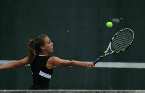 Senior captain Ali Dane reaches to make a backhanded return in her match against Quince Orchard. Dane, with her partner Olivia Matthews, won their doubles match 6-0, 6-0. Photo by Jonah Rosen.