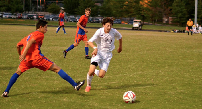 Holding midfielder Jeff Rosenberg goes at his man in the boys soccer 4-0 win over Watkins Mill.  Photo by Nick Anderson.