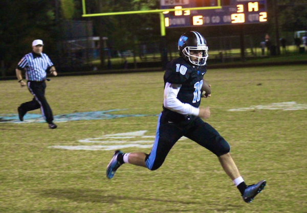 Quarterback Evan Smith tries to escape the Damascus pass-rush in the first half. Photo by Jonah Rosen. 