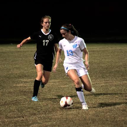 Wing Clare Severe dribbles the ball past a Wildcat player in the Sectional Semifinals Tuesday. Photo courtesy Michelle Jarcho.