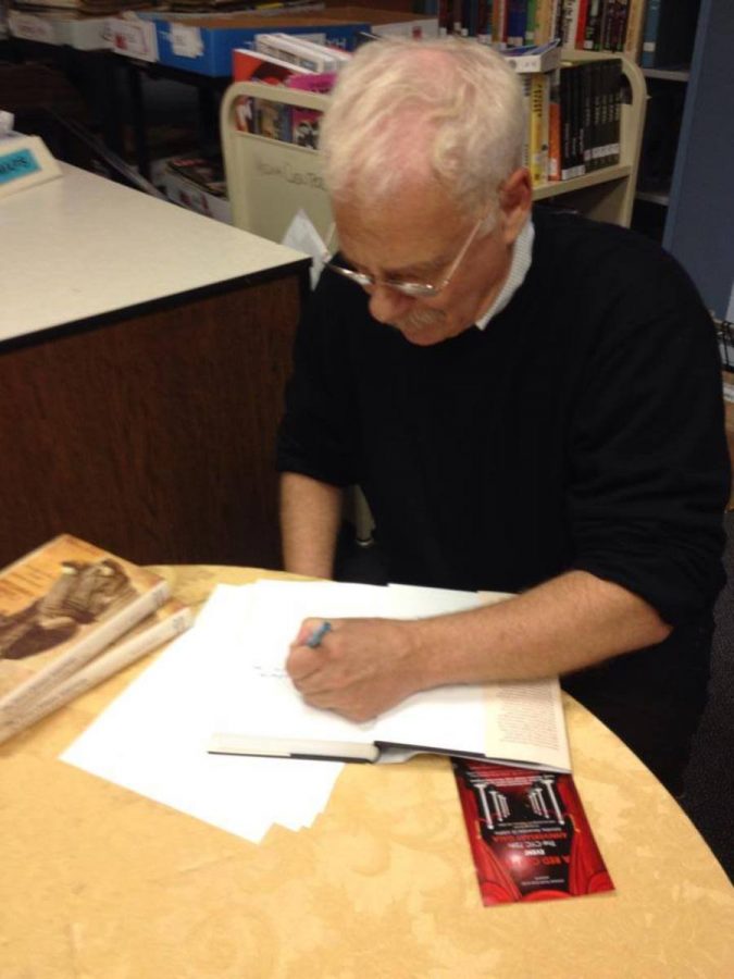 Scott Seligman signs copies of The First Chinese American in the Media Center. Photo courtesy Whitworld.