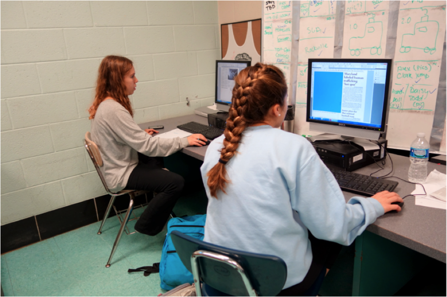 Copy Editor Caroline Schweitzer and production assistant Mikaela Fishman work on indesign to finish the paper. Photo by Sydney Schnitzer.