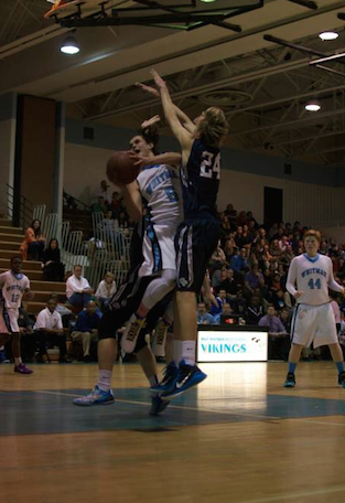 Riley Shaver drives to the hoop for the Vikings in their loss to Georgetown Prep. Photo by Nick Anderson.