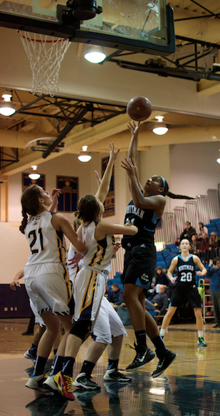 Guard Hannah Niles rises up over Baron defenders to score two of her 11 points in Thursdays win. Photo by Nick Anderson.