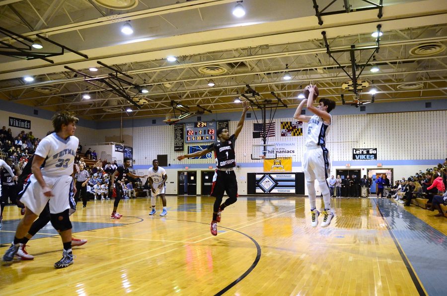 Guard Riley Shaver pulls up for a three in the basketball teams 69-62 loss to QO. Shaver had a game-high 21 points in the loss. Photo by Jordan Schnitzer.