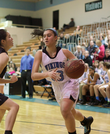Forward and senior captain Alison Poffley drives to the hoop to score two of her six points in the Vikings win over RM. Photo by Nick Anderson.