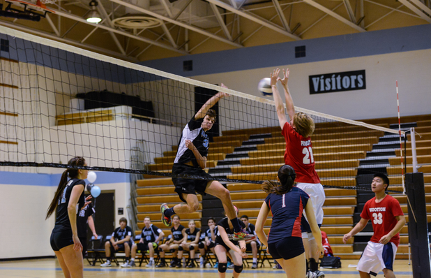Outside hitter Riley Shaver goes up for a spike against the Patriots. Photo courtesy Chris Hanessian. 
