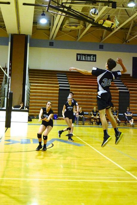 Outside hitter Riley Shaver goes up for a spike against Springbrook. Photo by Jordan Schnitzer.