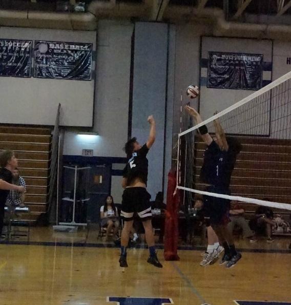 Outside hitter Nick Battan goes up to return a block. Photo by Carolyn Price.